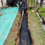 Men digging trench for landscaping project