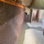 Interior basement waterproofing installation process.