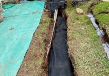 Men digging trench for landscaping project