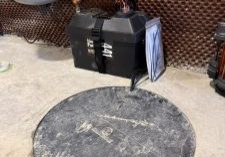 Round access cover on concrete floor for a battery backup sump pump