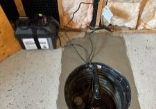 Sump pump installation in basement.