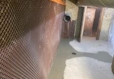 Interior basement waterproofing installation process.