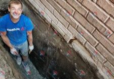 Man working on foundation waterproofing