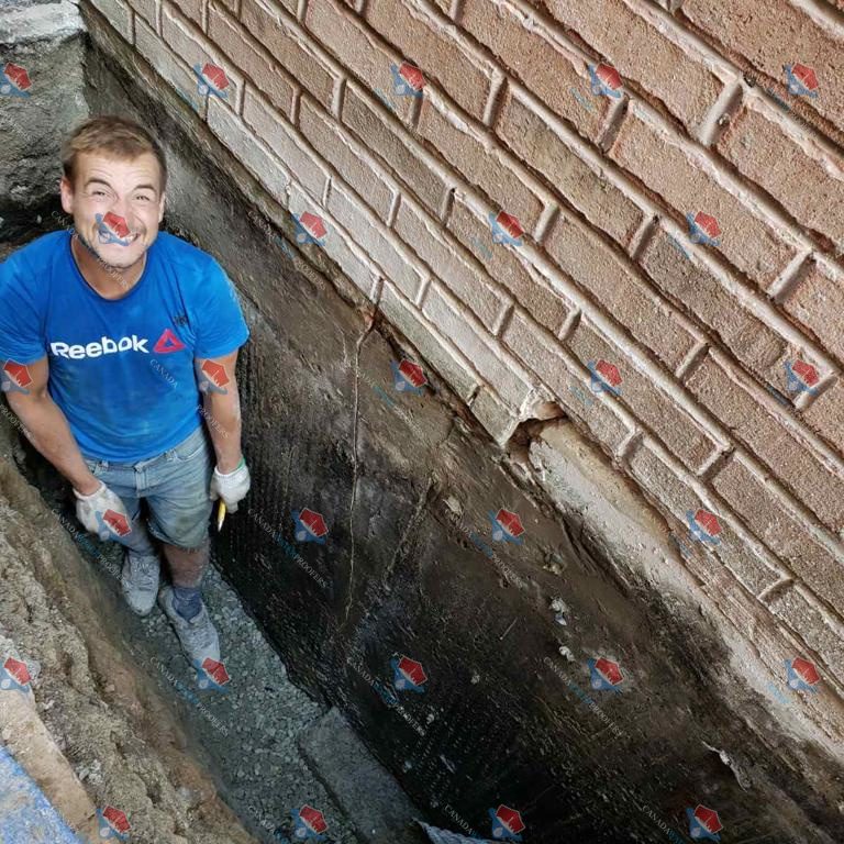 Man working on foundation waterproofing